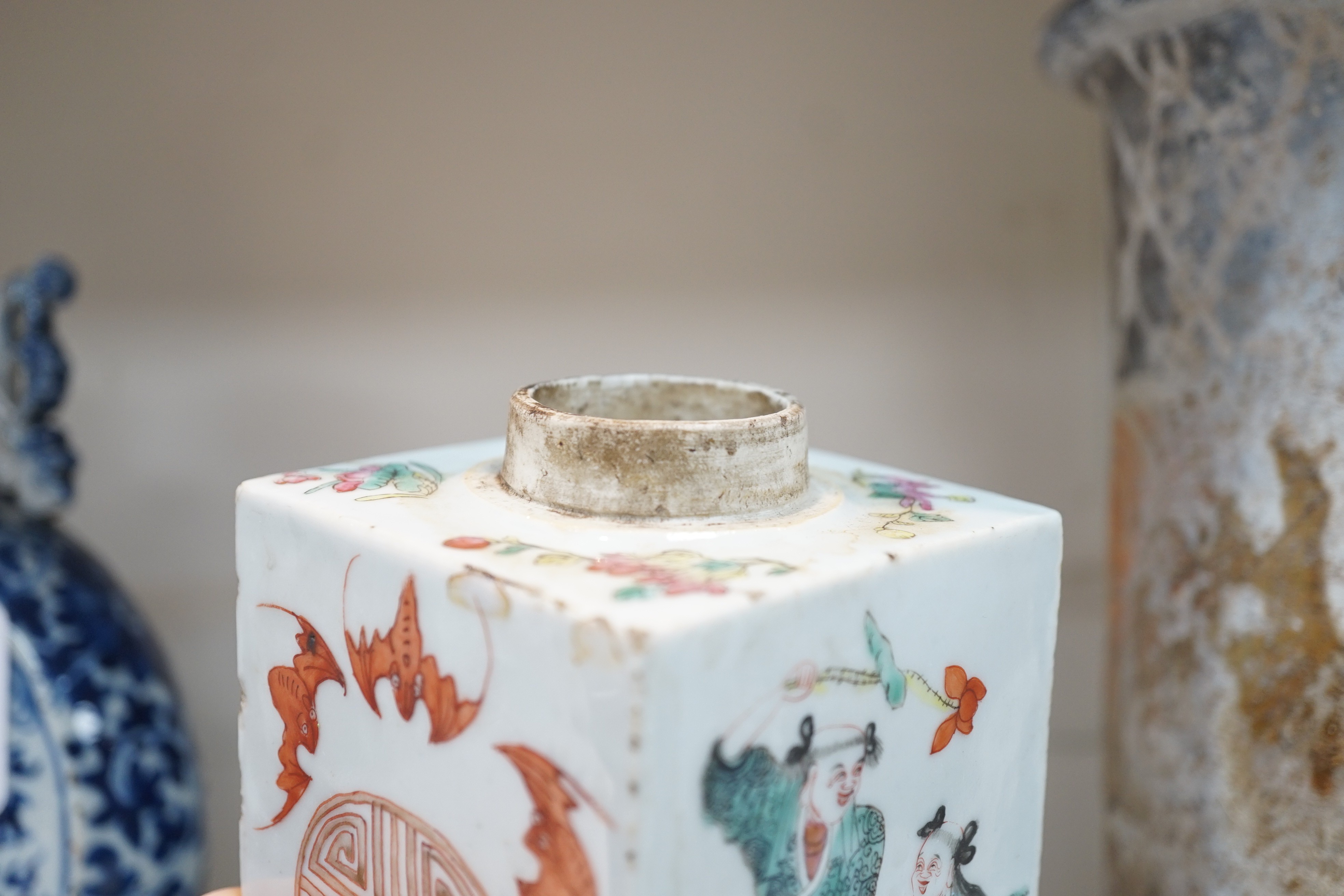 A Chinese famille rose square tea caddy, mid 19th century, 13.7cm high excluding wood stand and cover, slight damage
